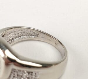 Silver ring with textured interior details.