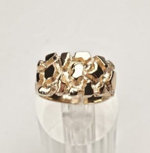 Gold ring with abstract design pattern.