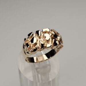 Gold ring with textured, abstract design.