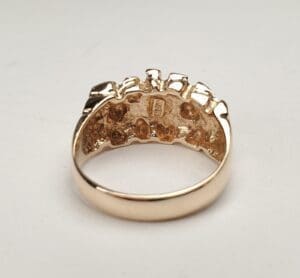 Gold ring with textured interior design.