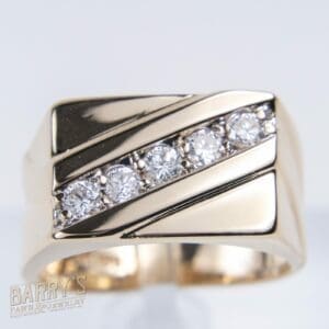 Gold ring with diagonal diamond accents.