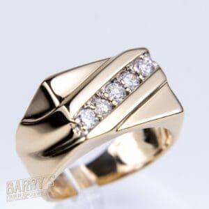 Gold ring with diamond accents, angular design.