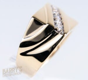 Gold ring with diagonal diamond accent.