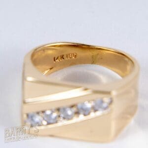 Gold ring with diamonds on display.