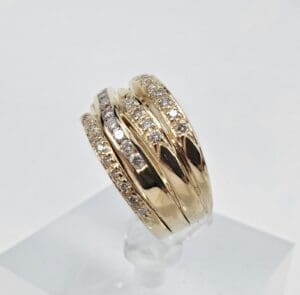 Gold ring with multiple diamond rows.