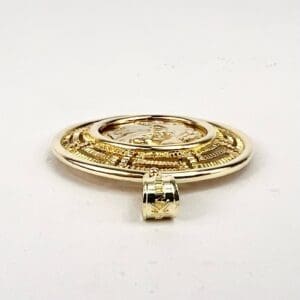 Gold medallion with intricate design.