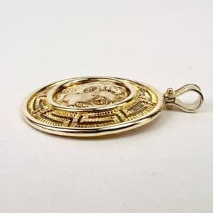 Gold and silver Medusa pendant with loop.