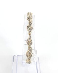 Gold bracelet with twisted leaf design.