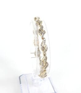 Gold bracelet with leaf pattern design.