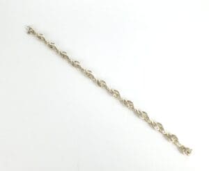Silver twisted bracelet on white background.