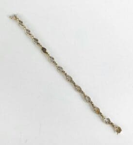 Gold and silver linked bracelet on white.