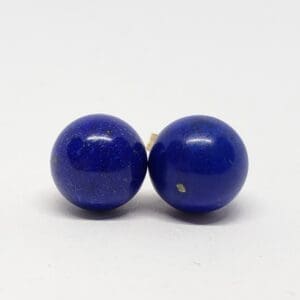 Two blue spherical lapis lazuli beads.