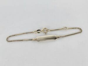 Gold identification bracelet with chain link.