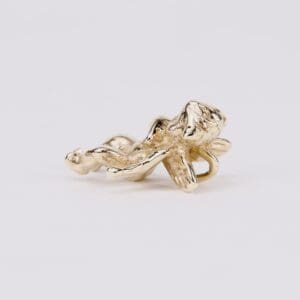 Gold dragonfly on white background.