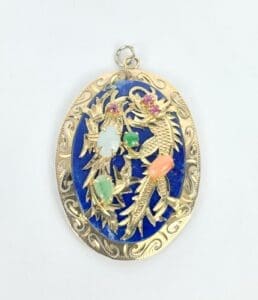 Ornate gold pendant with colorful gemstones.