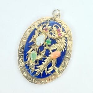 Ornate gold pendant with colorful gemstones.