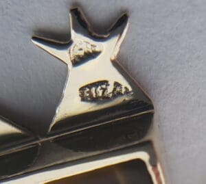 Close-up of a metal hallmark marking.