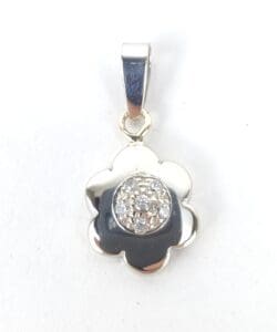 Flower-shaped silver pendant with sparkling center.