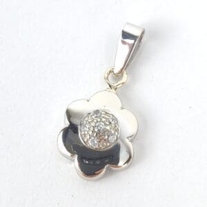 Flower-shaped silver pendant with rhinestones.