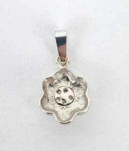 Silver flower-shaped pendant with loop attachment.