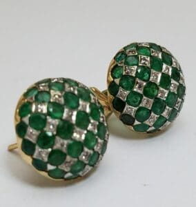 Gold earrings with green and white gemstones.