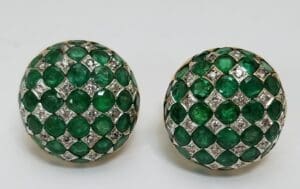Green gemstone earrings with diamond accents.