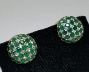 Green and silver checkered earrings on display.