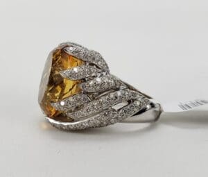 Diamond ring with large yellow gemstone.