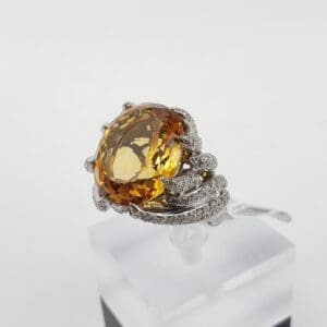 Ornate ring with large amber gemstone.