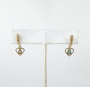 Heart-shaped earrings with turquoise stones.