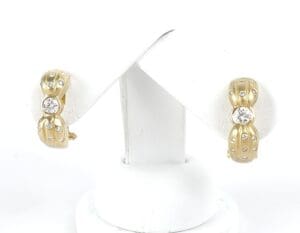 Gold and diamond stud earrings display.