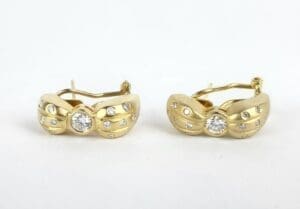 Gold earrings with diamond accents.