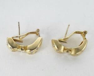Gold earrings with diamond accents.