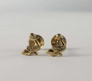 Gold earrings with diamond accents.
