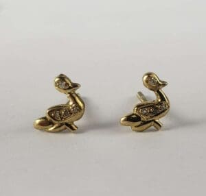 Gold duck-shaped earrings on white background.