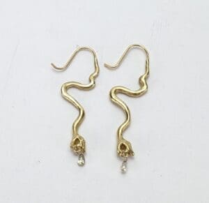 Gold snake earrings with crystal drops.