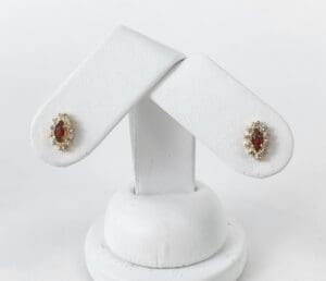 Gold and red gemstone earrings on display.