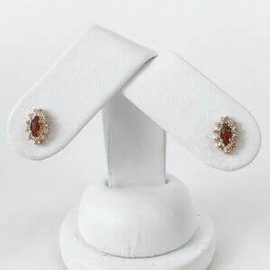 Gold and red gemstone earrings on display.