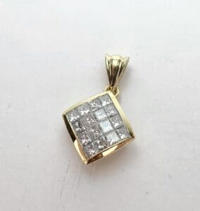 Gold pendant with square diamond pattern.