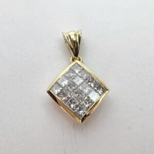 Gold pendant with square diamond arrangement.