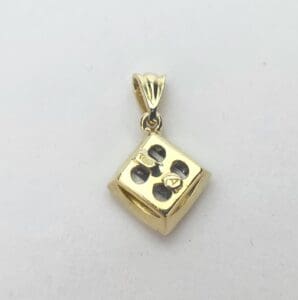 Gold dice pendant with number four.
