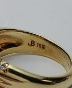 Gold ring with "JB 18K" engraving.