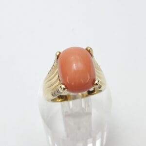 Gold ring with pink gemstone center.