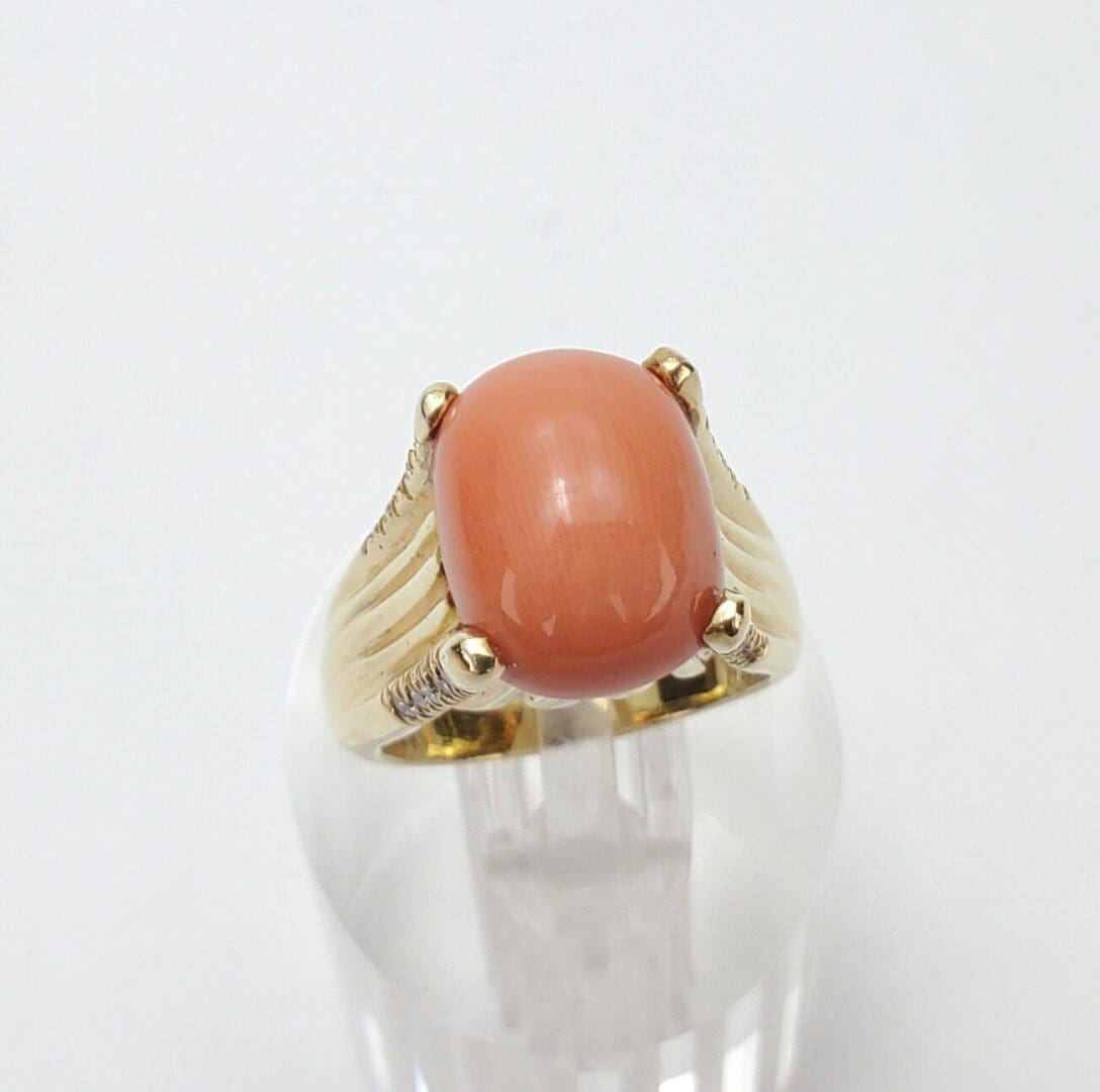 Gold ring with pink gemstone center.