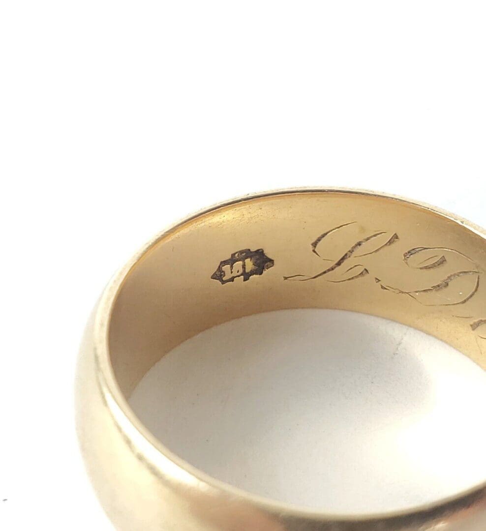 Close-up of engraved gold ring interior.