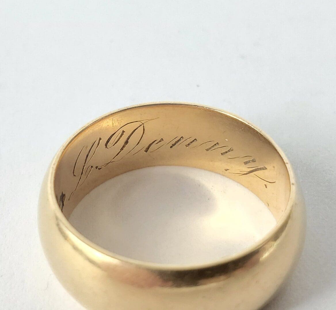 Gold ring with engraved inscription inside band.