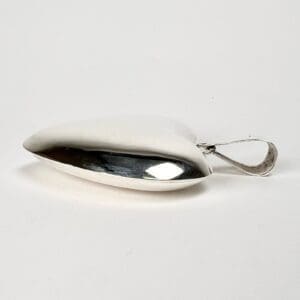 Silver spoon with a round, curved handle.