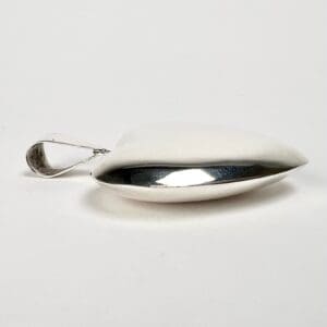 Silver spoon with unique, curved design.