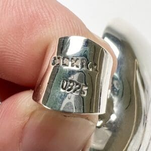 Silver ring with engraved hallmarks.