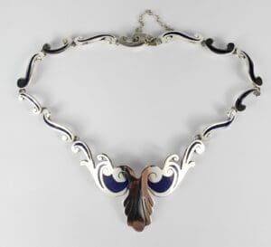 Silver and blue ornate necklace design.